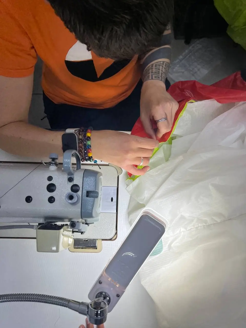 Sewing up a panel on a paraglider