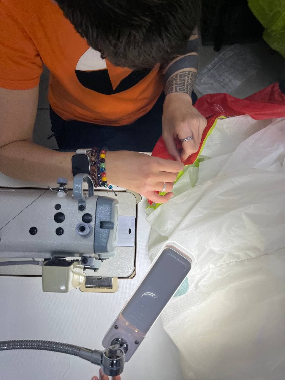 Sewing up a panel on a paraglider